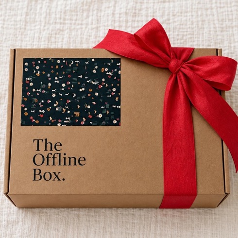 The Offline Box, Christmas Edition: a kraft gift box with a hand-printed lid and a red silk bow